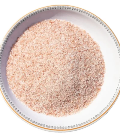 Fine grain Himalayan pink salt crystals neatly displayed in a round white decorative ceramic plate