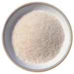 Medium granules of pure Himalayan light pink rock salt displayed neatly in a decorative bowl