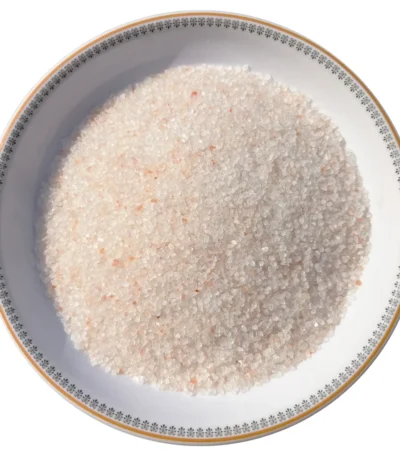 Medium granules of pure Himalayan light pink rock salt displayed neatly in a decorative bowl