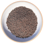 Coarse grain Himalayan black salt Kala Namak crystals neatly displayed in a round decorative ceramic plate