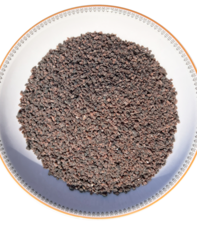 Coarse grain Himalayan black salt Kala Namak crystals neatly displayed in a round decorative ceramic plate