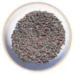 Coarse grain Himalayan dark pink rock salt crystals neatly displayed in a round decorative ceramic plate
