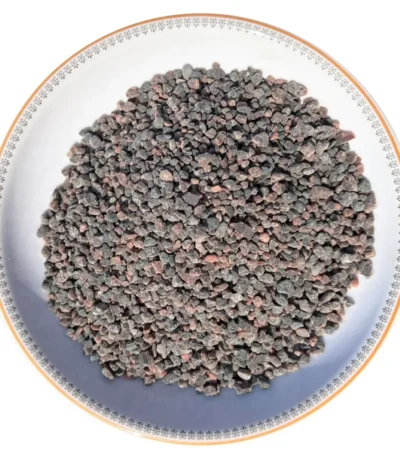 Coarse grain Himalayan dark pink rock salt crystals neatly displayed in a round decorative ceramic plate