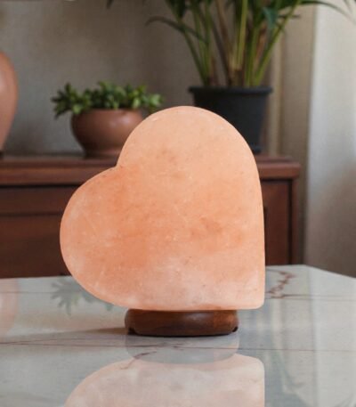 Handcrafted heart shape USB table lamp pink salt with smooth curved contours mounted on a dark circular wooden base
