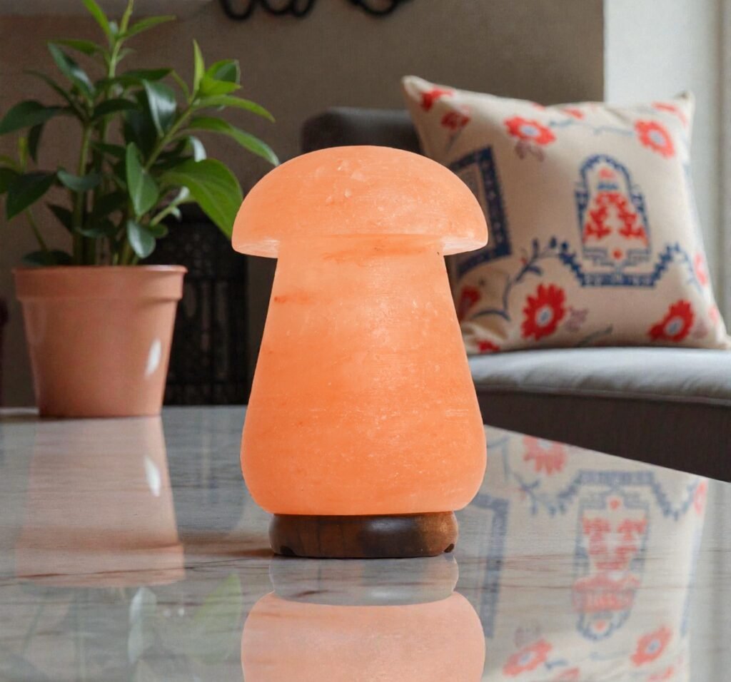 Handcrafted mushroom shape table lamp with smooth rounded cap carved from Himalayan pink salt mounted on a dark wooden base