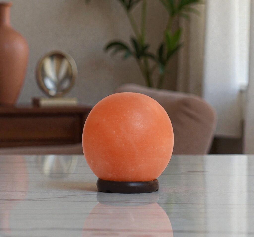 Handcrafted illuminated round shape USB lamp salt carved from Himalayan pink salt mounted on a dark circular wooden base