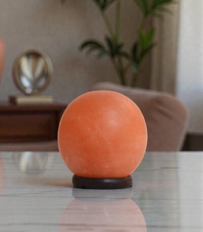 Handcrafted illuminated round shape USB lamp salt carved from Himalayan pink salt mounted on a dark circular wooden base