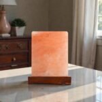 Handcrafted illuminated square table USB lamp carved from Himalayan pink salt mounted on a square dark wooden base