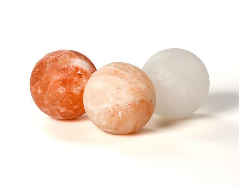 Handcrafted Himalayan Pink Salt Massage Balls - Natural Spa Therapy Three handcrafted smooth round Himalayan pink salt massage balls in red, peach, and white crystal shades.