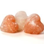 Handcrafted smooth heart-shaped Himalayan pink salt massage stone carved from pure rock salt crystal.