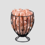 Handcrafted black wire goblet basket on pedestal base filled with raw Himalayan pink salt crystal chunks.