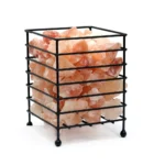 Handcrafted square matte black metal wire basket on ball feet filled with raw Himalayan pink salt crystal chunks.