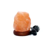 Handcrafted natural shape USB mini Himalayan pink salt lamp mounted on a dark wooden base with black USB cable.