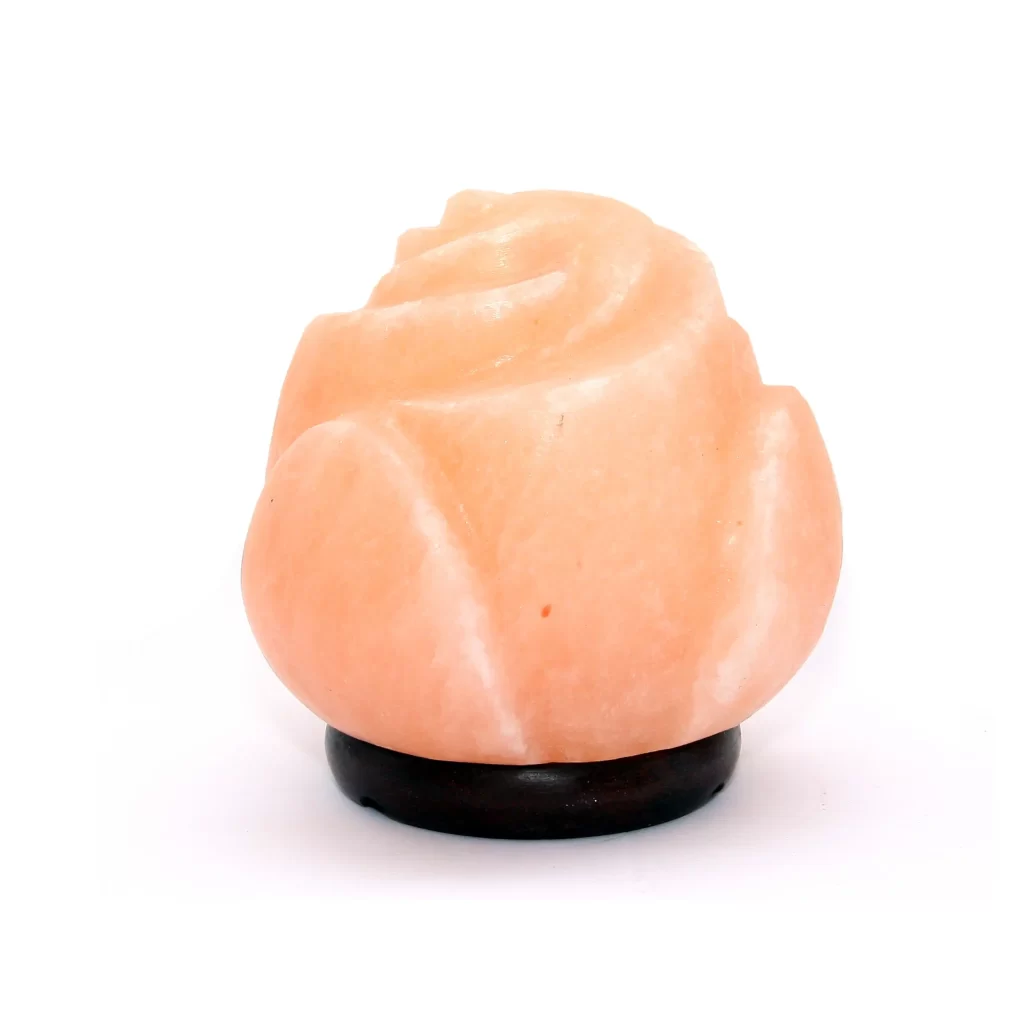 Handcrafted mini USB rose shaped Himalayan pink salt lamp with sculpted petal layers mounted on a dark circular wooden base.
