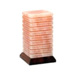 Handcrafted USB lined cube shaped Himalayan pink salt lamp with horizontal etched grooves mounted on a dark wooden base.