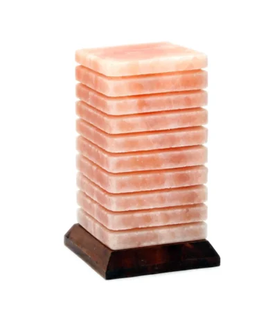 Handcrafted USB lined cube shaped Himalayan pink salt lamp with horizontal etched grooves mounted on a dark wooden base.