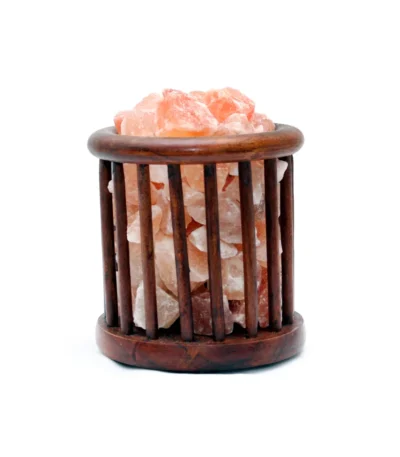 Handcrafted cylindrical dark wooden basket filled with raw Himalayan pink salt crystal chunks.