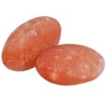 Two handcrafted smooth oval Himalayan pink salt massage stones carved from pure rock salt crystal.