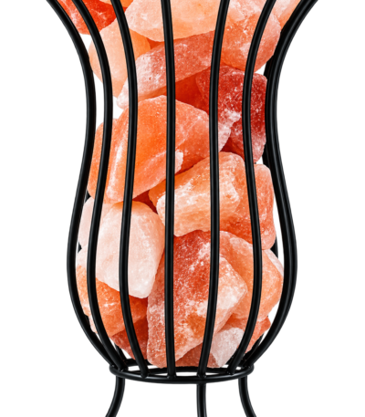Black metal wire vase basket salt lamp on tripod feet filled with natural Himalayan pink rock salt chunks on a marble surface