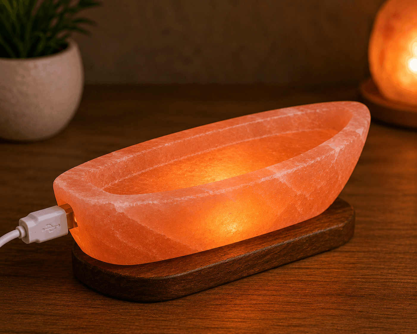 USB Boat Salt Lamp - Desktop Wellness Decor Handcrafted illuminated USB boat salt lamp carved from Himalayan pink salt mounted on a dark elongated wooden base