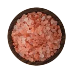 Coarse granules of pure Himalayan pink salt displayed neatly in a decorative bowl