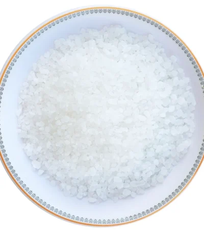 Coarse grain Himalayan white rock salt crystals neatly displayed in a round decorative ceramic plate