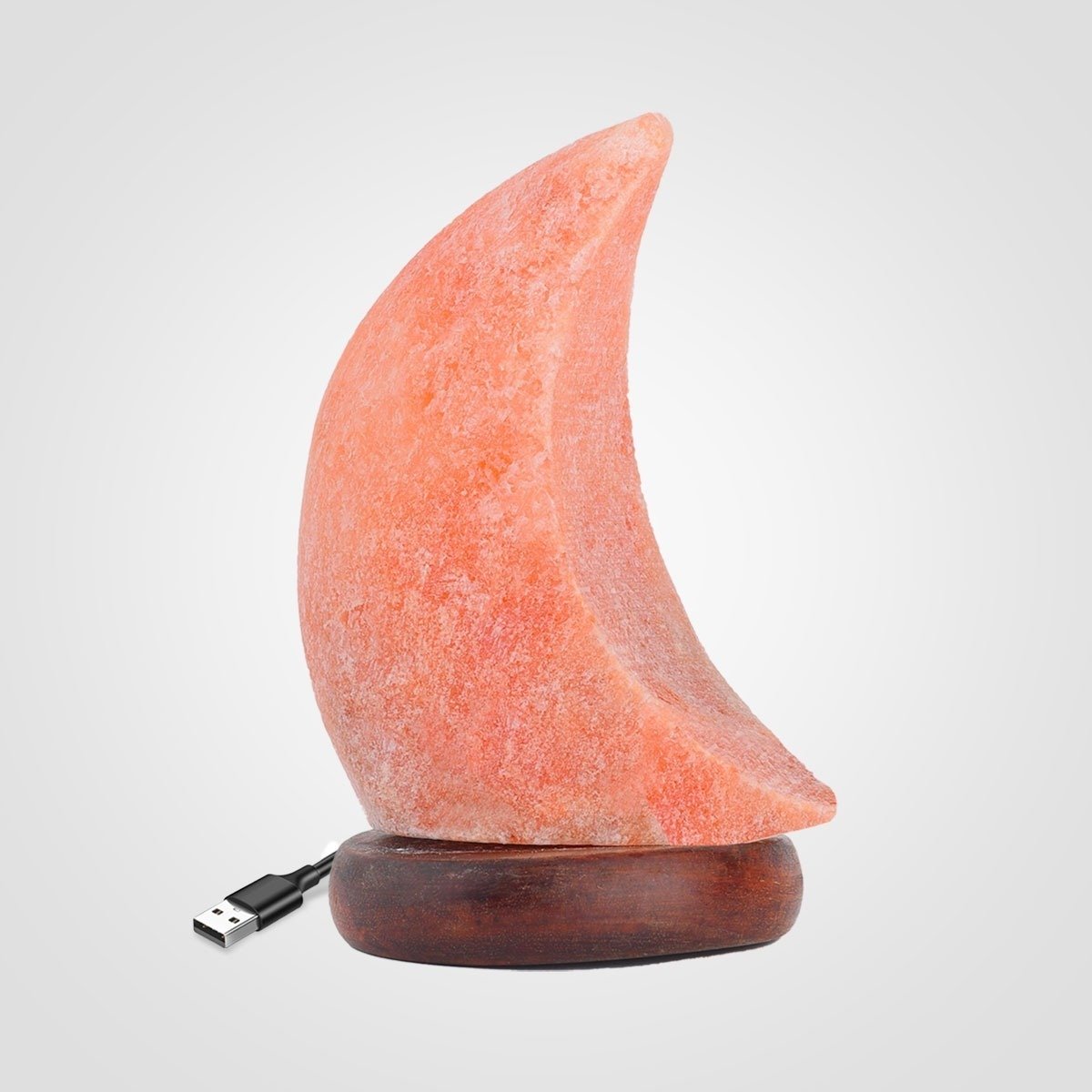 USB Crescent Moon Salt Lamp - Desktop Wellness Decor Handcrafted USB crescent moon shaped Himalayan pink salt lamp mounted on a dark circular wooden base with USB cable