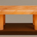 Handcrafted Himalayan pink salt bench with four cylindrical pillars mounted on a dark rectangular wooden base
