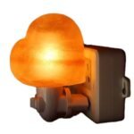 Handcrafted heart shape Himalayan pink salt wall plug-in night light plugged into an electrical outlet